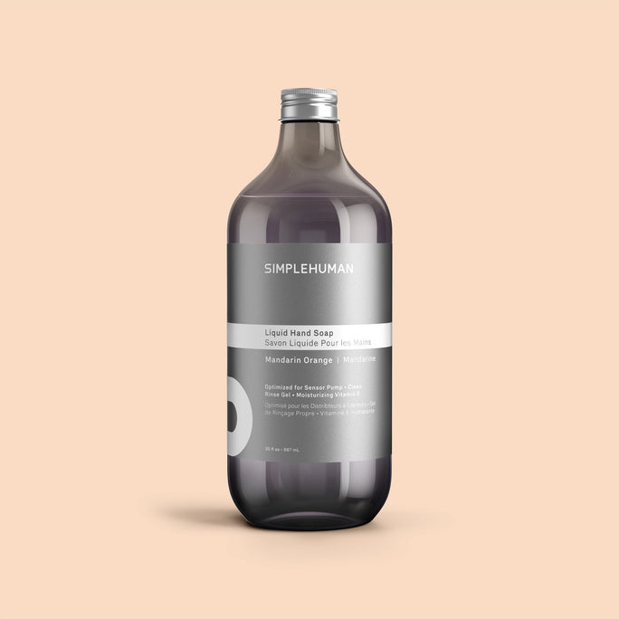 Simplehuman's Mandarin Orange Liquid Hand Soap Refill Bottle on a colored background.