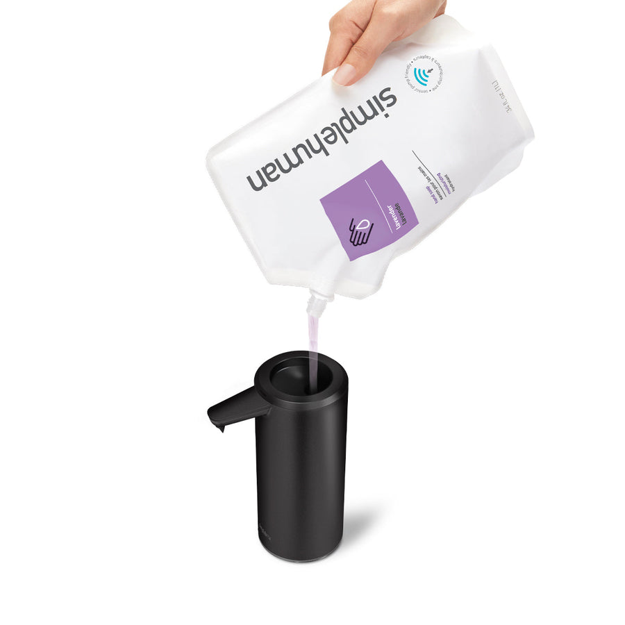 Detail view of Simplehuman Matte Black 9 oz. Sensor Pump being refilled with soap, wide easy-refill opening.