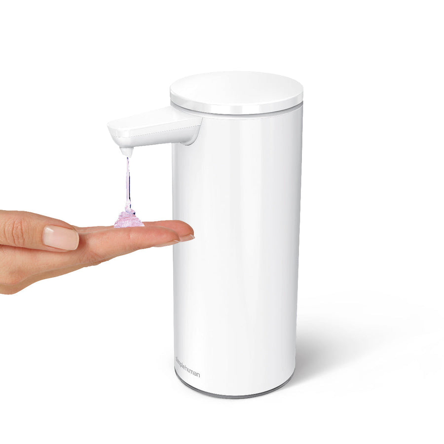 Angled view of Simplehuman 9 oz. Rechargeable Sensor Pump in White dispensing soap, hands-free usage.