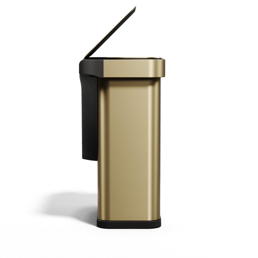 Simplehuman's Sensor Can in Matte Gold Side view showcasing the lid being opened and the black trim around the can.
