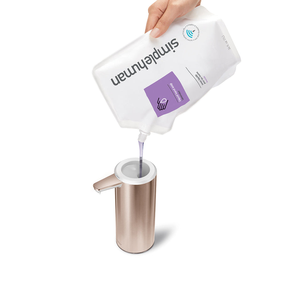 Overhead Refilling view of Simplehuman 9 oz. Sensor Pump in Rose Gold being filled with soap pouch, wide funnel for easy refill.