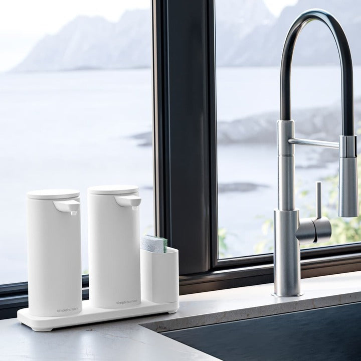 Simplehuman Dual Sensor Pump 14 oz + Caddy in White, providing organized, touch-free soap dispensing by a kitchen sink.