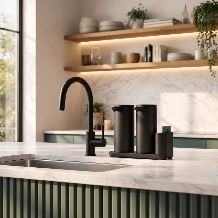 Simplehuman's Dual 14 oz. Sensor Pump in Matte Black in a modern kitchen setting with marble counter top and a hint of green.