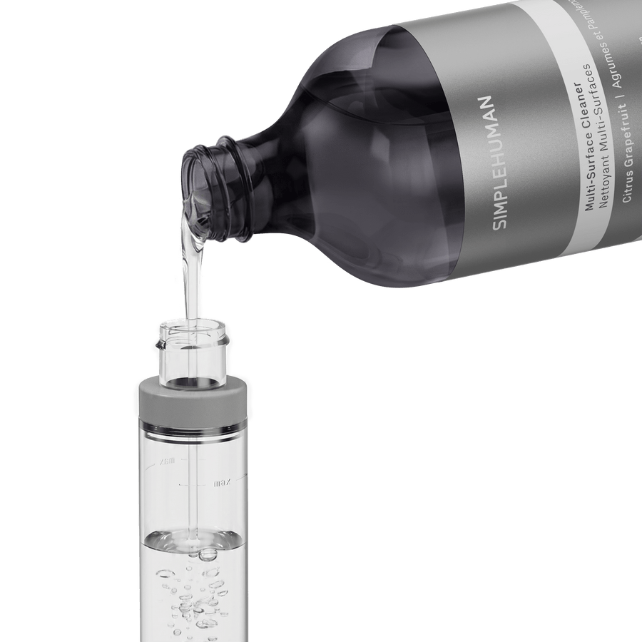Simplehuman's Refill Bottle filling a Simplehuman Paper Towel Holder with Spray. 