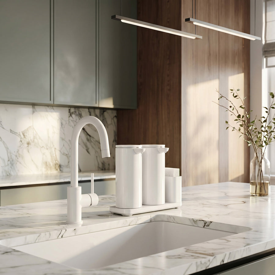 Simplehuman's Dual 14 oz. Sensor Pump in White in a modern kitchen setting with marble counter top and wooden cabinets.