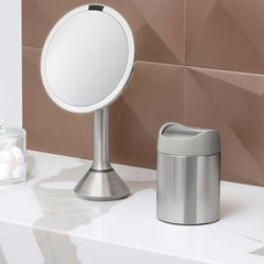 mini can - brushed stainless steel w/ grey trim - lifestyle on counter with mirror and cotton balls image