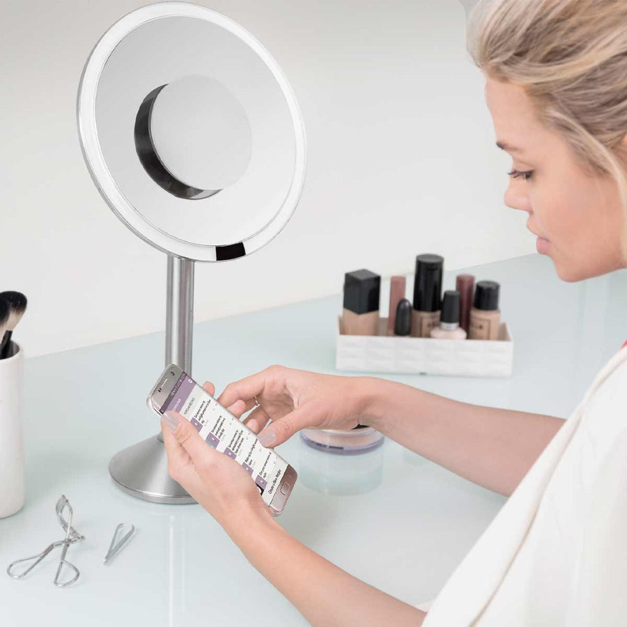 Lifestyle view: Simplehuman Sensor Mirror Pro Round, Brushed Stainless Steel, using connected smartphone app to control tru-lux light.