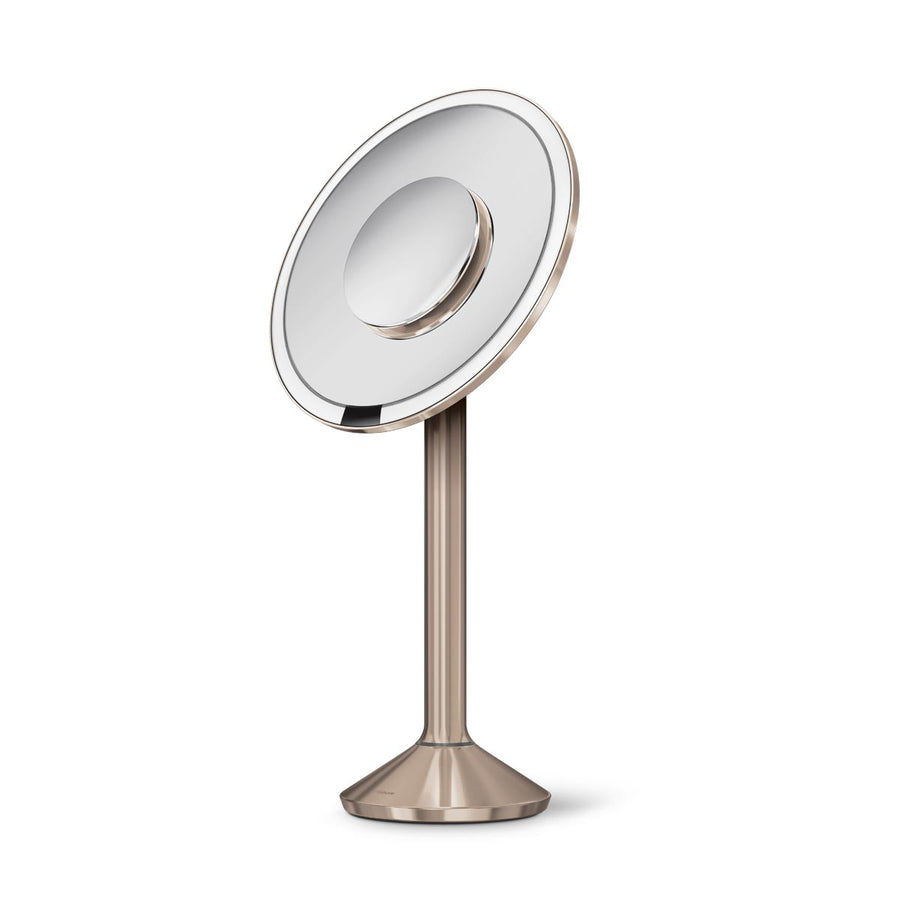 Studio view of Simplehuman Sensor Mirror Pro Round in Rose Gold, hands-free sensor and magnetic zoom mirror.