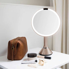 sensor mirror with touch-control brightness and dual light setting - rose gold finish - lifestyle in bedroom image